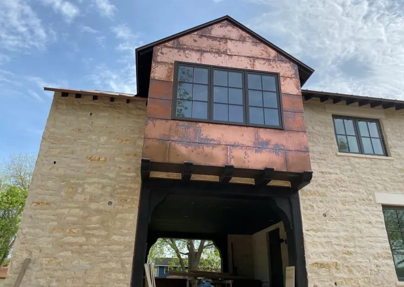 Copper metal panel facade on a stone building for Roof Repair in Granite City