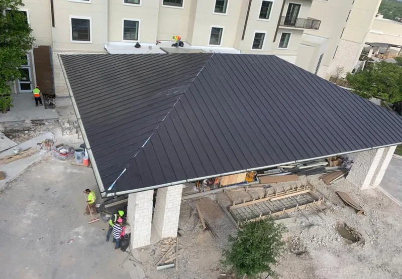 Metal roofing installation team working on a commercial building in Granite City